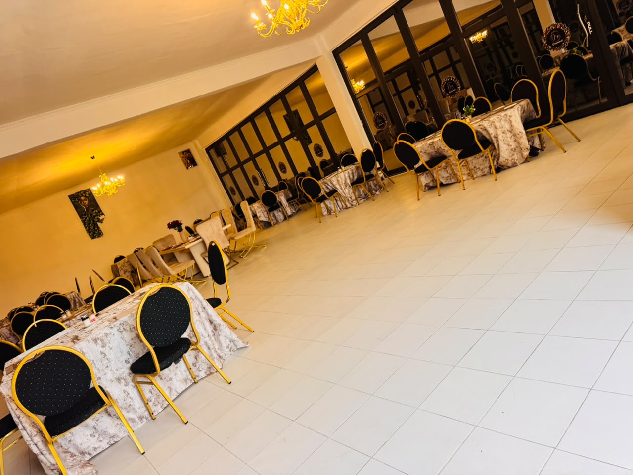Dining hall with black and gold chairs at DreamWoods, Masvingo