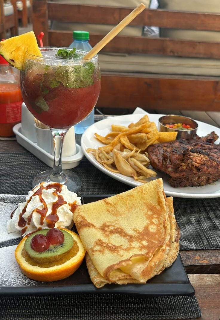 Grilled steak with chips, a fresh mocktail and pancakes with cream and fruit at DreamWoods, Masvingo