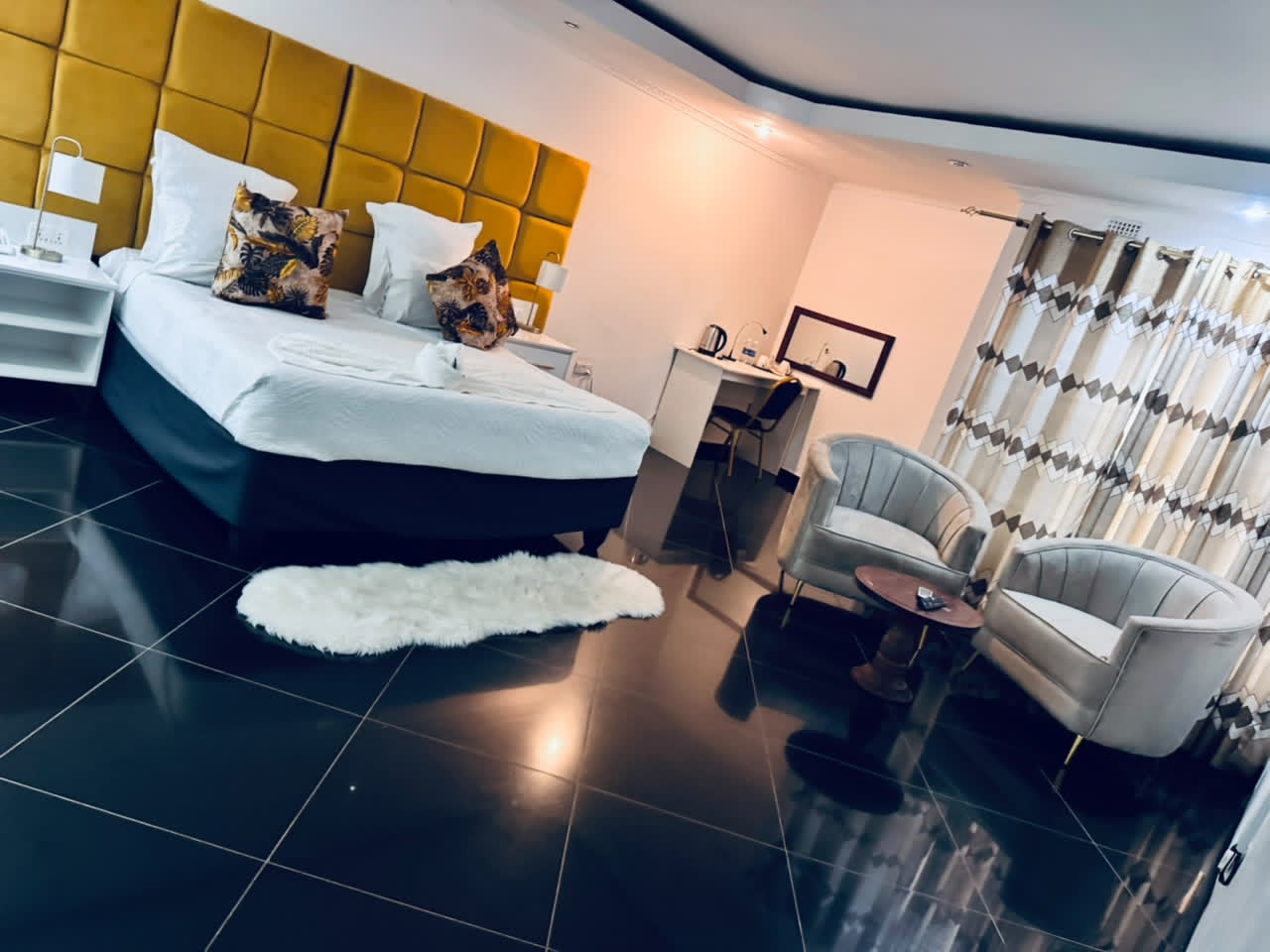Spacious room with polished black floor at DreamWoods, Masvingo